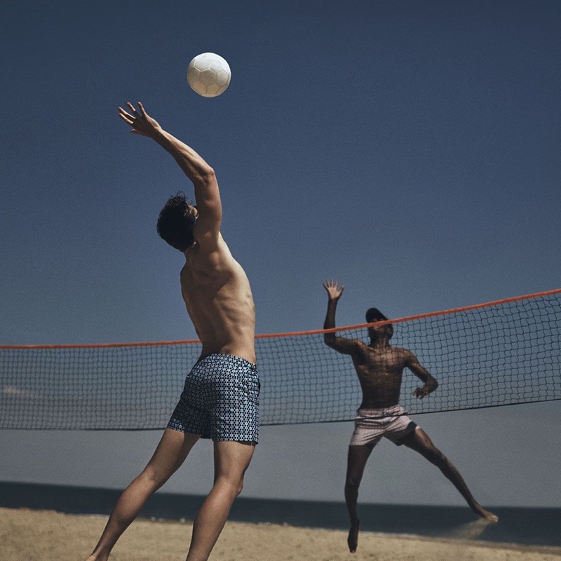 Playing volleyball, Edward Wilding and O'Shea Robertson don Orlebar Brown swimwear.