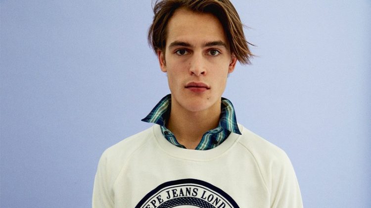 Model Parker van Noord sports a Pepe Jeans pullover with a button-down and jeans.