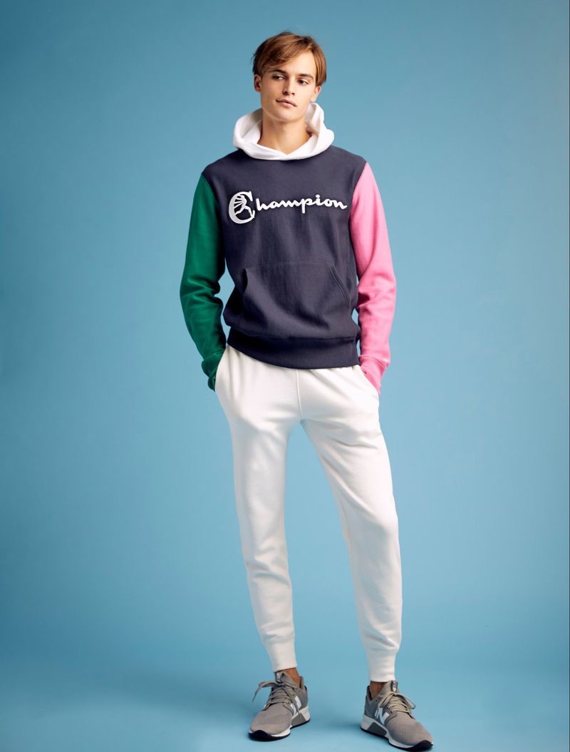 Showcasing resort style, Parker van Noord dons a Todd Snyder + Champion color block hoodie and white jogger sweatpants.