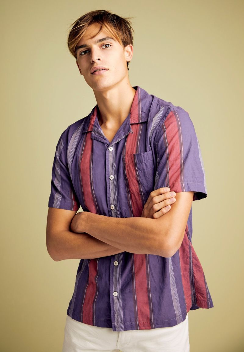 Connecting with Todd Snyder, Parker van Noord models a short-sleeve striped camp-collar shirt.