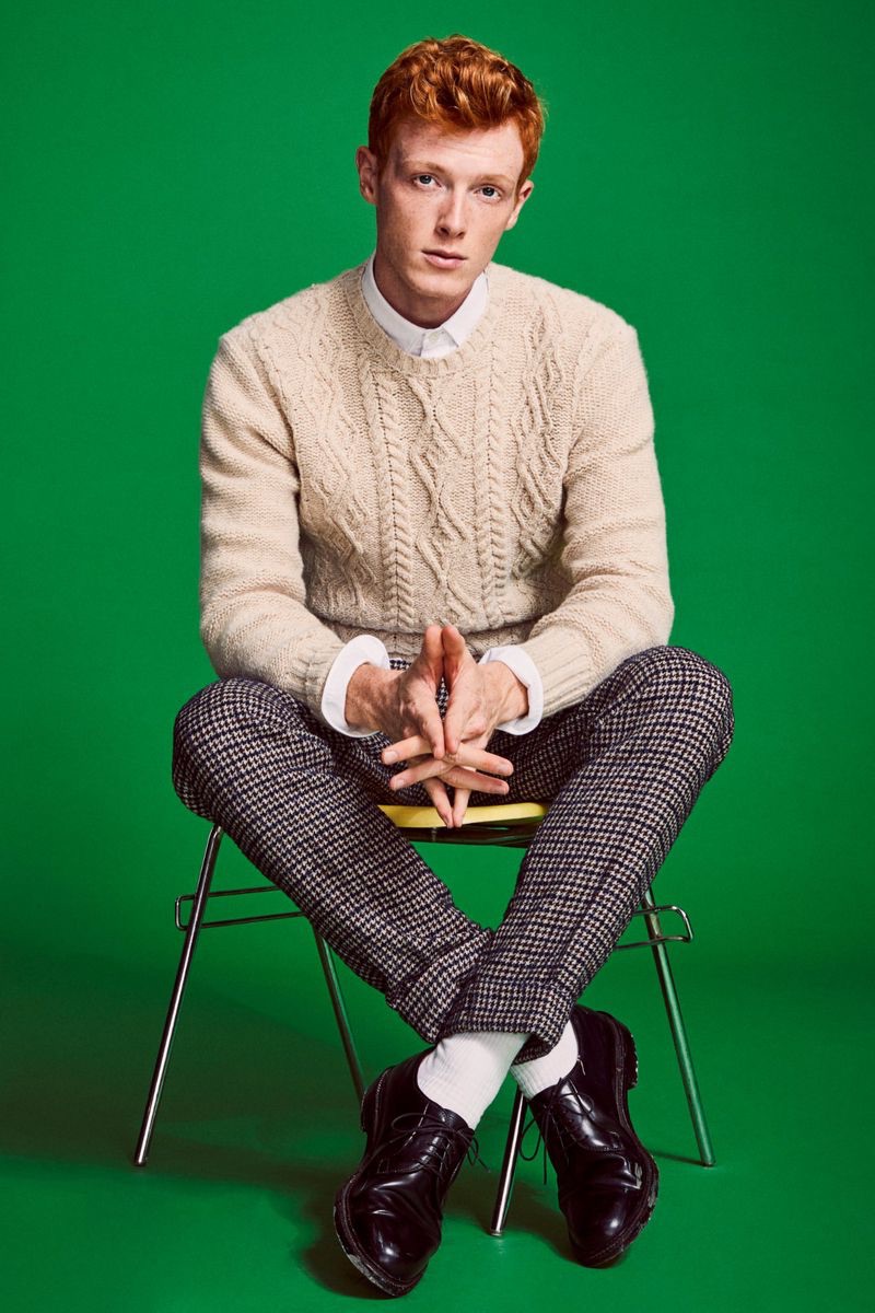 Dressed to impress, Linus Wordemann models an Inis Meain cable-knit sweater with a Todd Snyder houndstooth trousers.