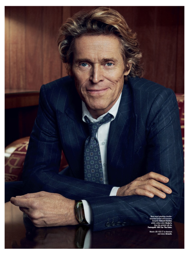 All smiles, Willem Dafoe dons a bespoke Edward Sexton pinstripe suit.