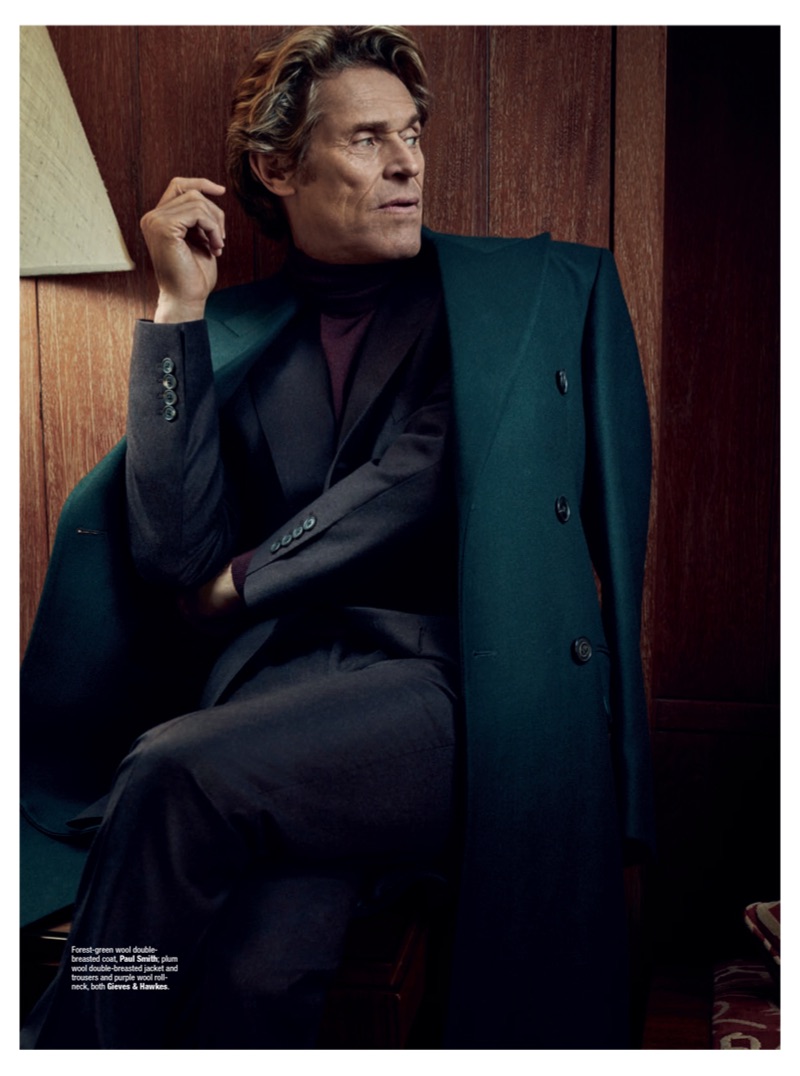 A sleek vision, Willem Dafoe wears a Paul Smith double-breasted coat with a sweater and suit by Gieves & Hawkes.