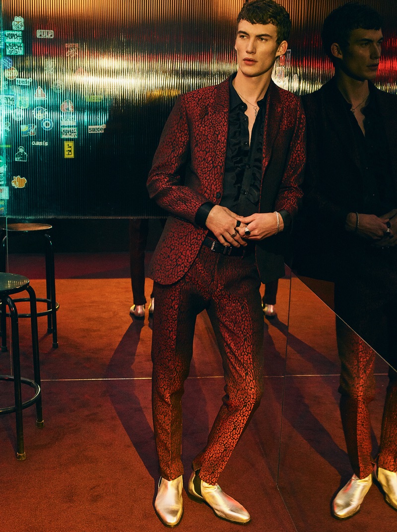 Model Lukas Adriaensens makes a statement in a red printed suit and gold boots, courtesy of Zara Man.