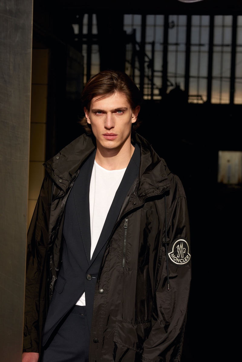 Model Edoardo Sebastianelli wears a Moncler coat with a Dsquared2 suit and a tee by The White Briefs.