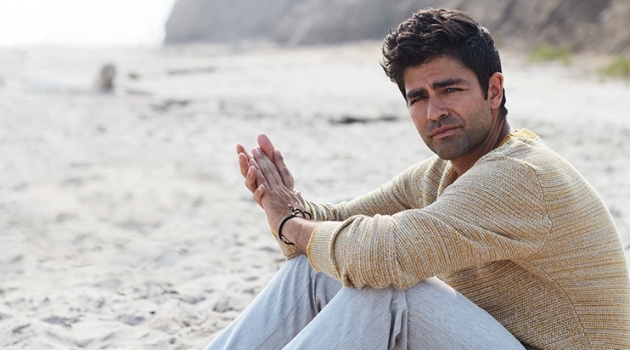Adrian Grenier Hits the Beach with Alive, Discusses Sustainability Taking to the beach, Adrian Grenier wears a Selected Homme sweater and life/after/denim trousers.