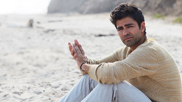 Taking to the beach, Adrian Grenier wears a Selected Homme sweater and life/after/denim trousers.