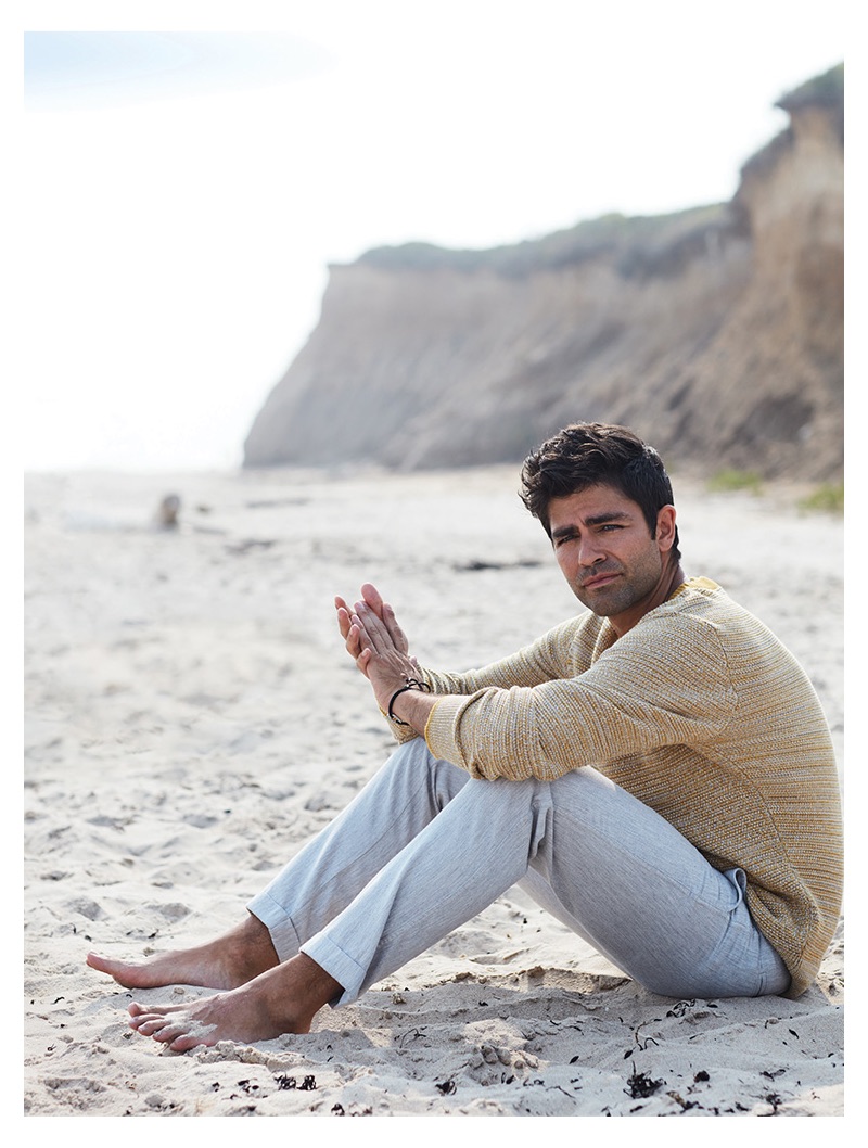 Taking to the beach, Adrian Grenier wears a Selected Homme sweater and life/after/denim trousers.