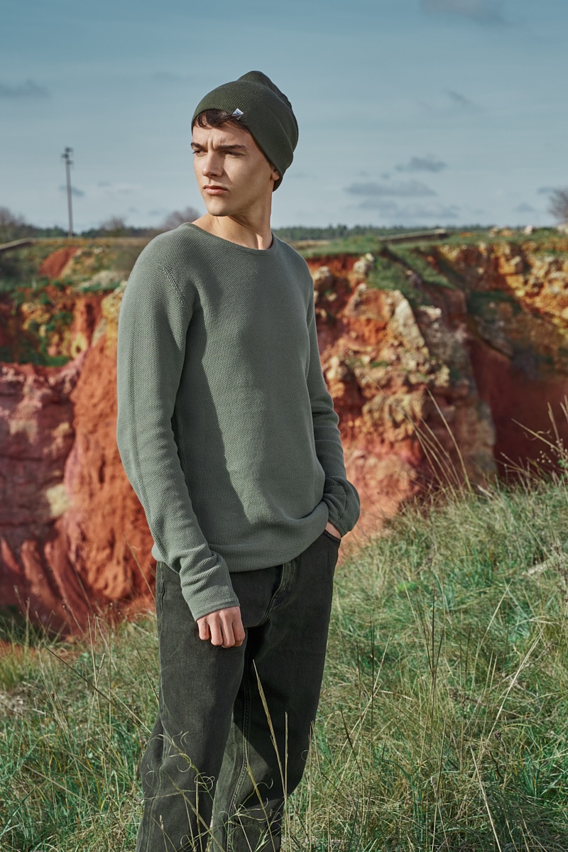 Alessandro wears knit beanie RVLT, sweater Minimum, and jeans Cheap Monday.