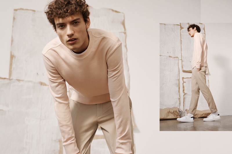 Embracing light hues, Serge Rigvava wears a pink sweatshirt with Connor stretch chinos by Club Monaco.