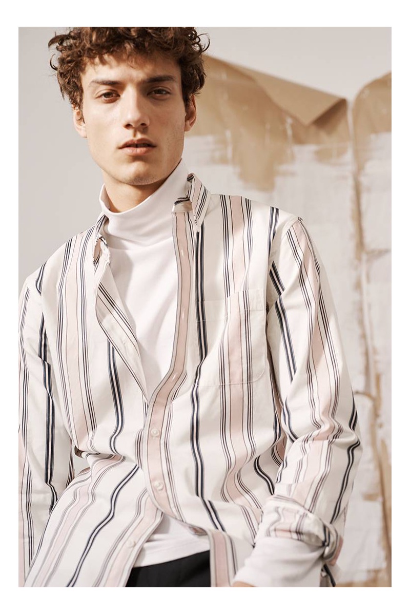 Layering, Serge Rigvava sports a Club Monaco striped shirt with a turtleneck.