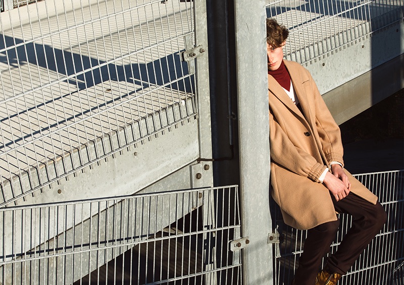 Donning an oversized camel coat, Elias wears a look from Kenzo.