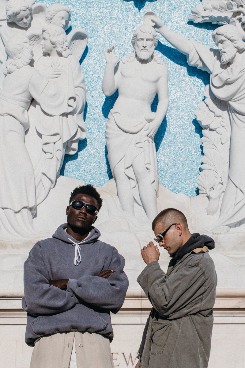 Left to Right: Remi wears sunglasses Gucci, his own hoodie, and vintage trench coat Dior.  Blake wears 1960s acetate "Cobain" sunglasses and a vintage Safari duster Banana Republic, c/o Pastime Paradise.