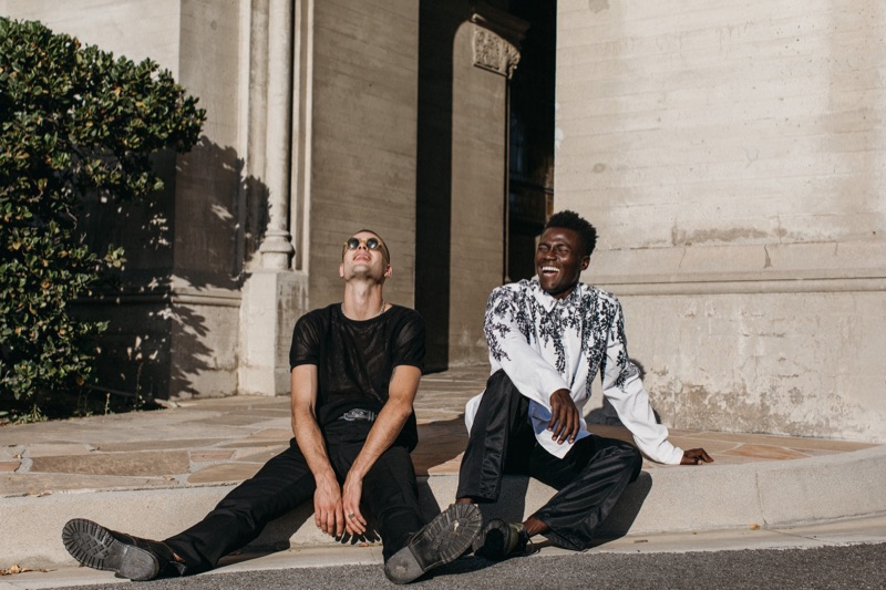 Left to Right: Blake wears mesh top Dries Van Noten, trousers Yves Saint Laurent, and 1960s yellow acetate "Lennon" sunglasses. He also sports a vintage belt and boots courtesy of Pastime Paradise. Remi wears printed shirt Ann Demeulemeester, track pants Our Legacy, and vintage boots John Fluevog, courtesy of Pastime Paradise.