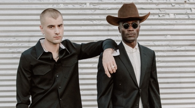 Blake Hardy & Remi Alade in 'No Trespassing' Left to Right: Blake wears shirt Calvin Klein, trousers Yves Saint Laurent, and vintage cowboy boots. Remi wears cowboy hat Stetson, suit Balmain, vintage French shirt and cowboy boots.
