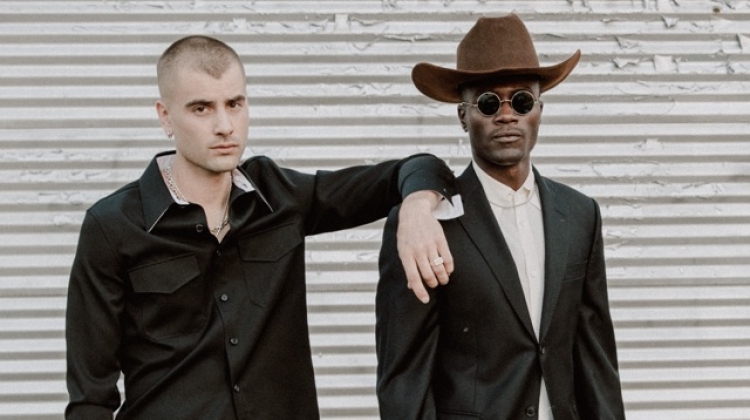 Left to Right: Blake wears shirt Calvin Klein, trousers Yves Saint Laurent, and vintage cowboy boots. Remi wears cowboy hat Stetson, suit Balmain, vintage French shirt and cowboy boots.