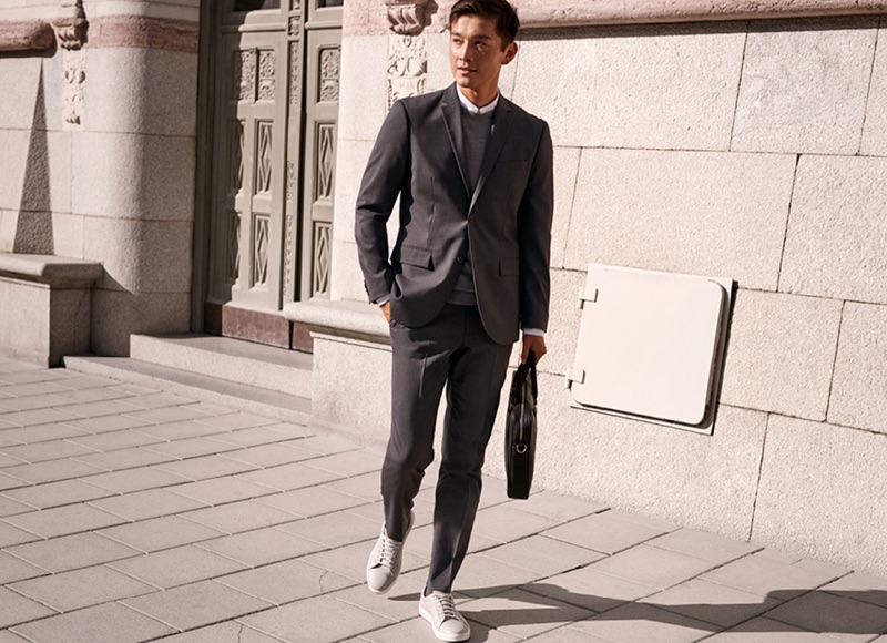 Daisuke Ueda models a grey slim fit suit from H&M.