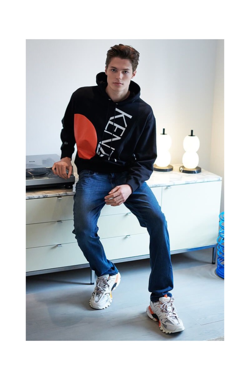 Going casual, Brodie Scott wears Kenzo color block logo hoodie with Balenciaga track sneakers.