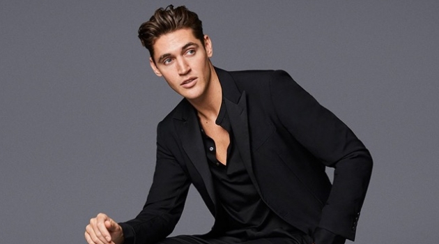 Isaac Carew Sports Must-Have Shoes for Jimmy Choo Spring '19 Campaign Isaac Carew dons Jimmy Choo's black shiny calf loafers with white rope binding.