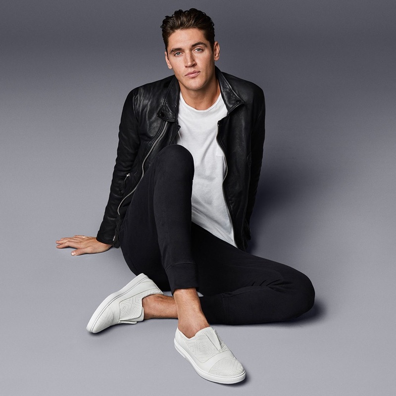 Front and center, Isaac Carew models Jimmy Choo's white embossed diamond weave leather and sport calf slip-on trainer.