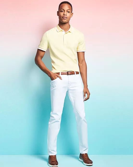 Front and center, Conrad Bromfield dons a yellow Michael Kors polo shirt.