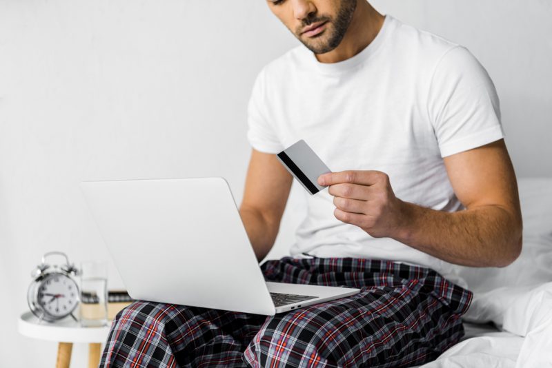 Man Shopping Online in Pajamas