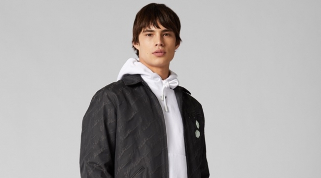 Shop Mr Porter's Exclusive Off-White Capsule Model Louis Baines rocks an Off-White logo jacket, red wide-leg pants, hoodie, PVC belt, and high-top sneakers.