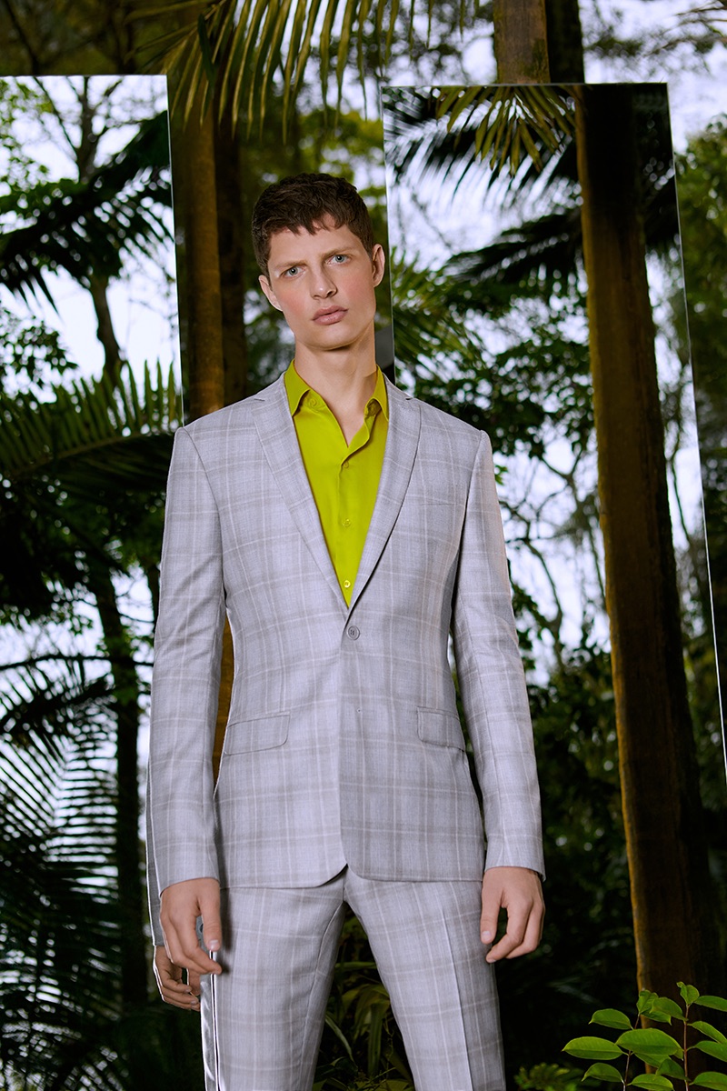 Douglas Lima sports a checked grey suit for Ricardo Almeida's summer 2019 campaign.