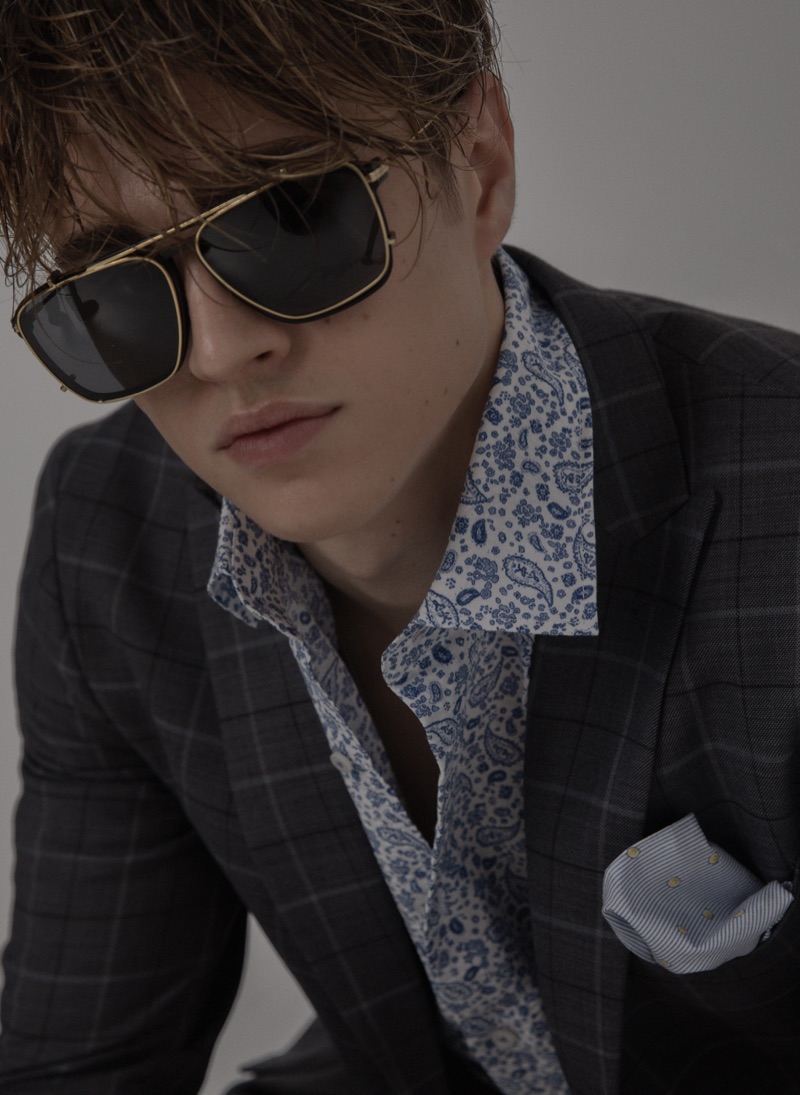Sebastian wears suit jacket Reserved, sunglasses Jerome Boateng, shirt, and handkerchief Eterna.
