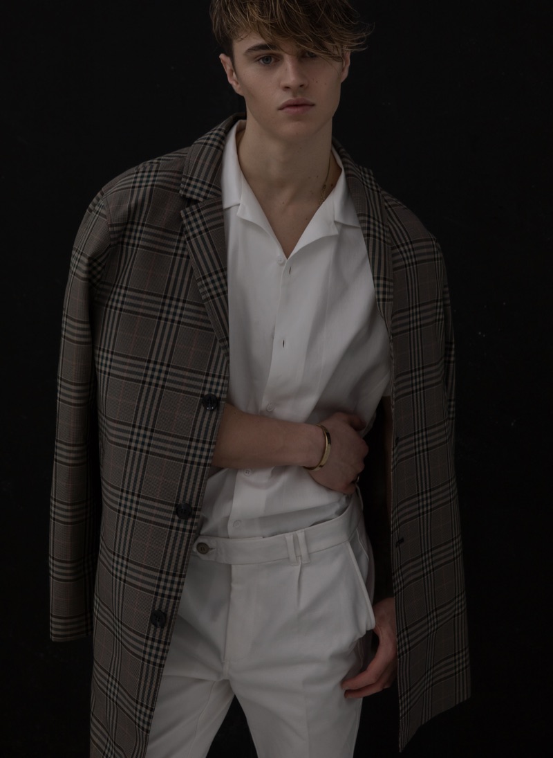 Sebastian wears coat Samsøe & Samsøe, shirt ASOS, and trousers Reserved.