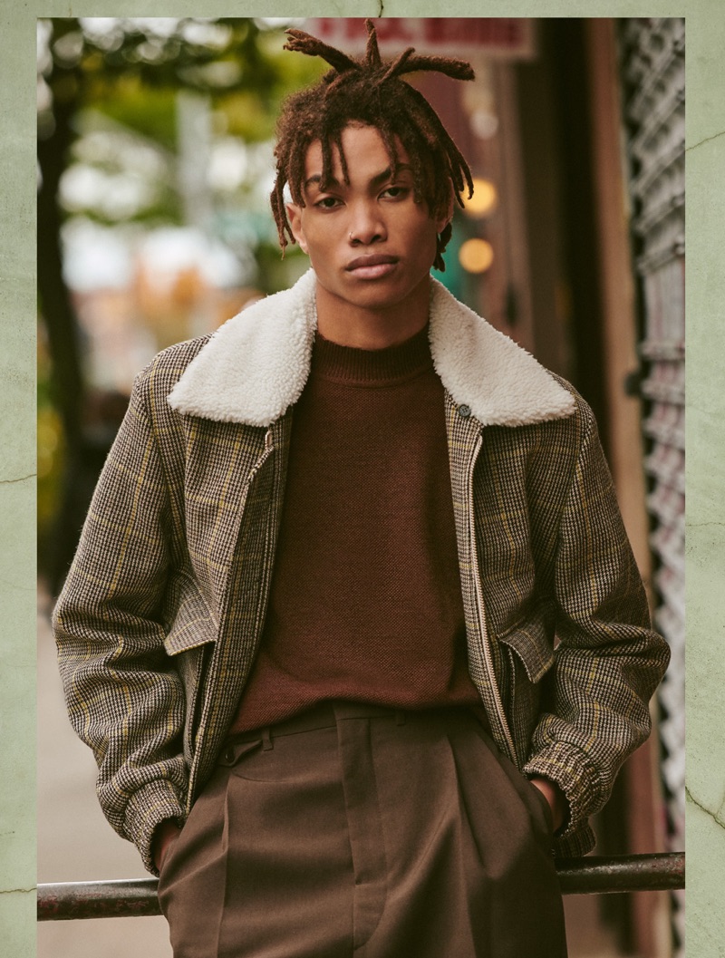 Reuniting with East Dane, Seth Hill sports a Kenzo jacket, De Bonne mock neck sweater, and Lemaire pleated trousers.