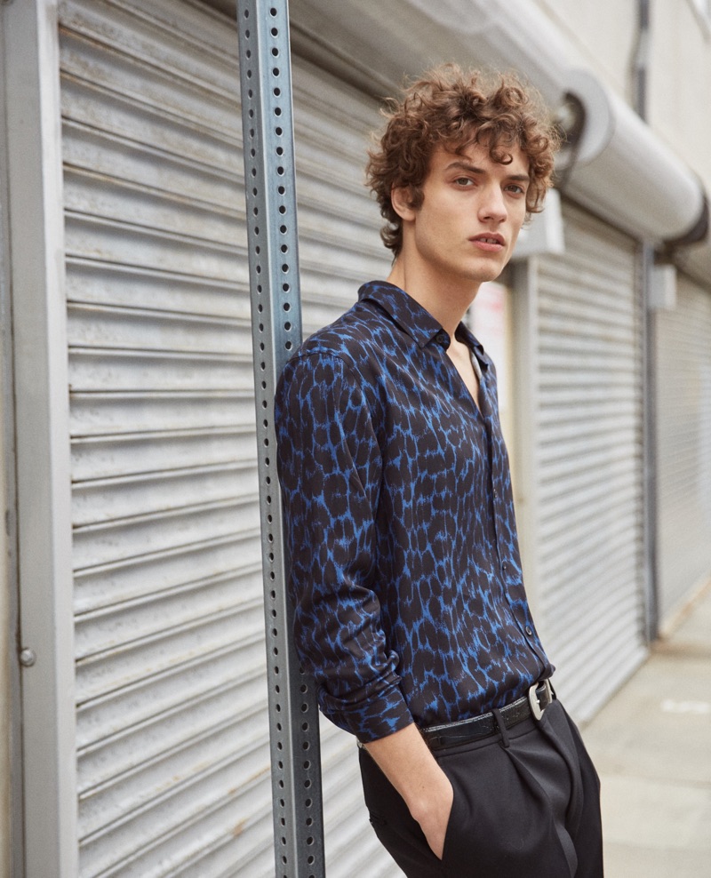 Sporting a leopard print shirt, Serge Rigvava sports a spring look by The Kooples.
