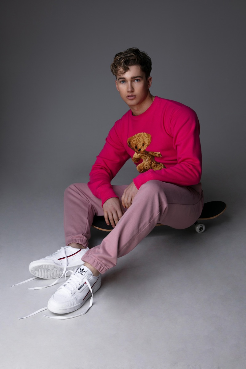 Starring in a new photo shoot, AJ Pritchard dons a Gucci teddy bear sweatshirt.
