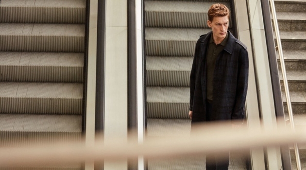 Riding the escalator, Bastian Thiery models a spring-summer 2019 look from Corneliani.