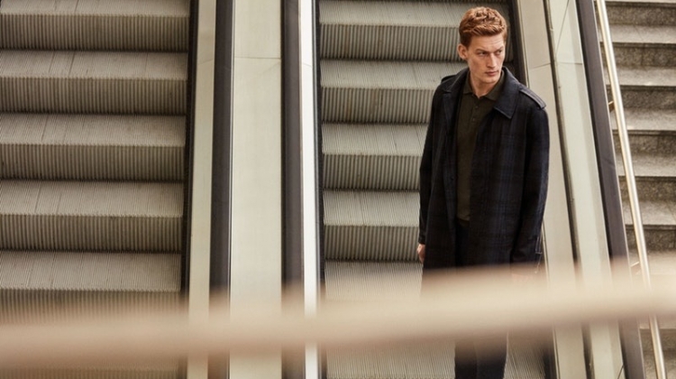 Riding the escalator, Bastian Thiery models a spring-summer 2019 look from Corneliani.