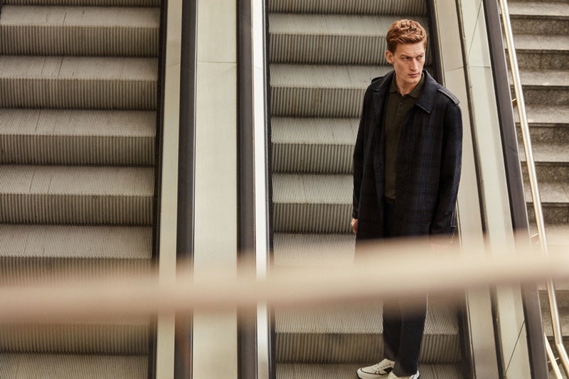 Riding the escalator, Bastian Thiery models a spring-summer 2019 look from Corneliani.