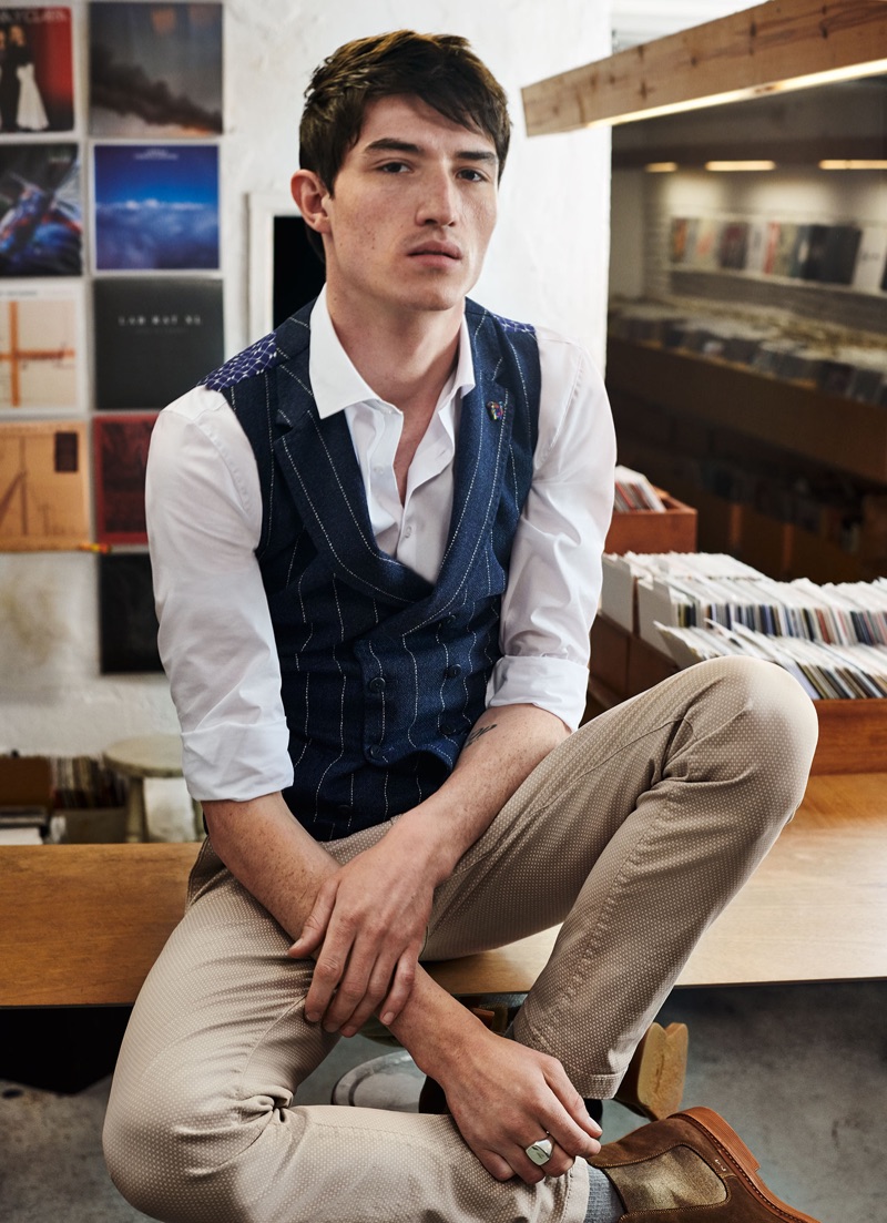 Inspiring in a smart look, Jester White wears a Digel Move shirt, pinstriped vest, and slim-fit pants.