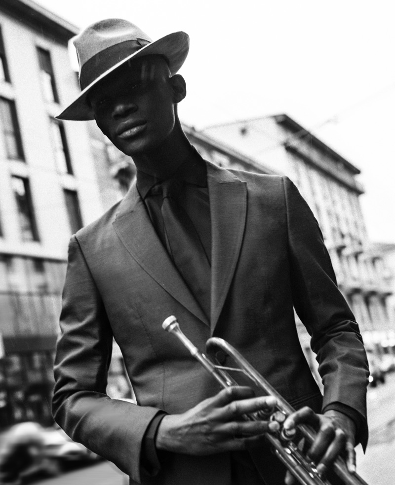 Omar wears hat Borsalino, shirt, tie, and two-button suit Ermenegildo Zegna Couture.