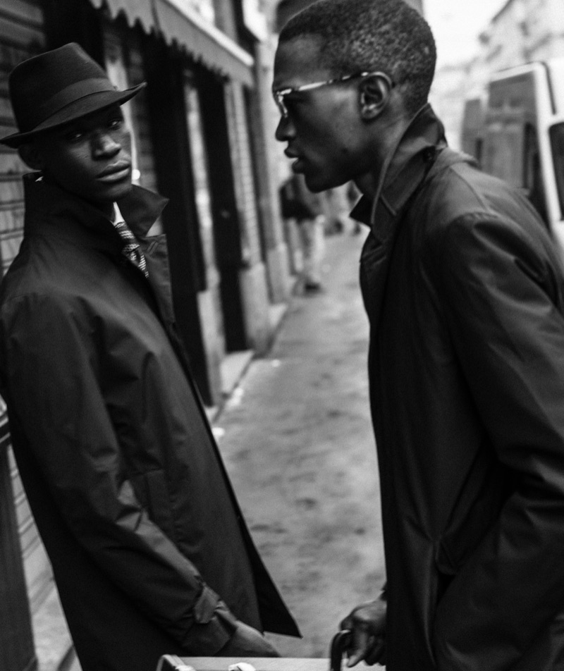 Left: Omar wears trench Corneliani, hat Borsalino, shirt, and tie Corneliani. Right: Alejandro wears trench Luigi Bianchi Mantova and sunglasses Salvatore Ferragamo.