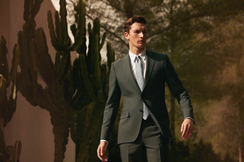 Donning a sharp suit, Oli Lacey appears in Gieves & Hawkes' spring-summer 2019 campaign.