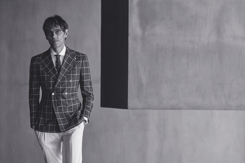 Sporting glasses, Didier Vinson wears a windowpane print double-breasted jacket from Luigi Bianchi Mantova.