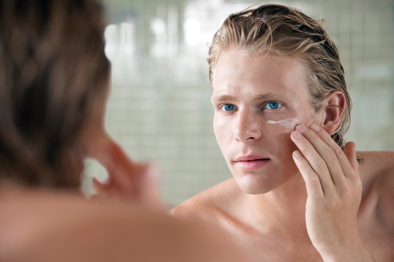Man with Facial Cream in Mirror