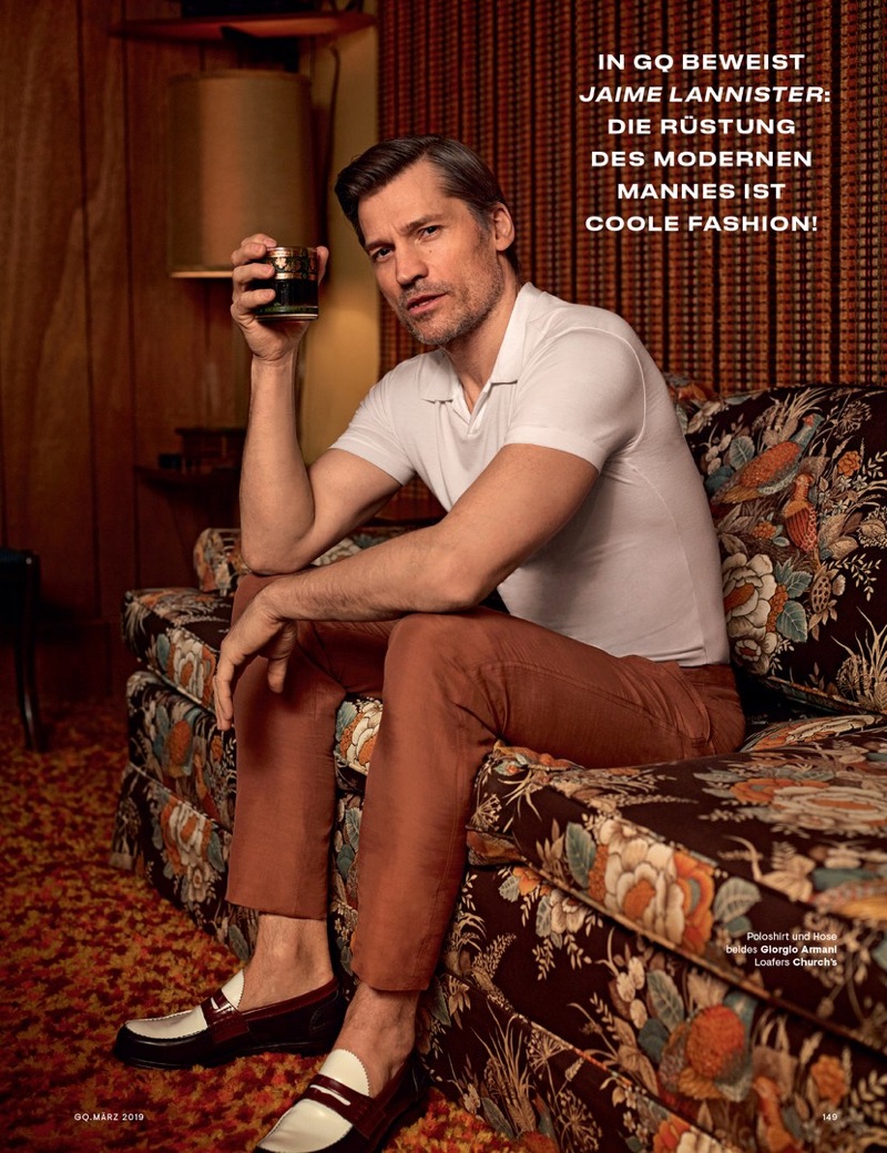 Starring in a new photo shoot, Nikolaj Coster-Waldau wears a Giorgio Armani polo and trousers with Church's loafers.