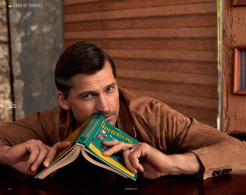 Reading a book, Nikolaj Coster-Waldau sports Brunello Cucinelli.