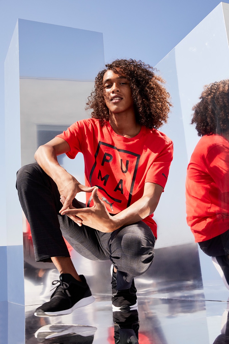 Rocking a red PUMA t-shirt, Leo Hoye-Egan connects with Nordstrom for a sporty outing.