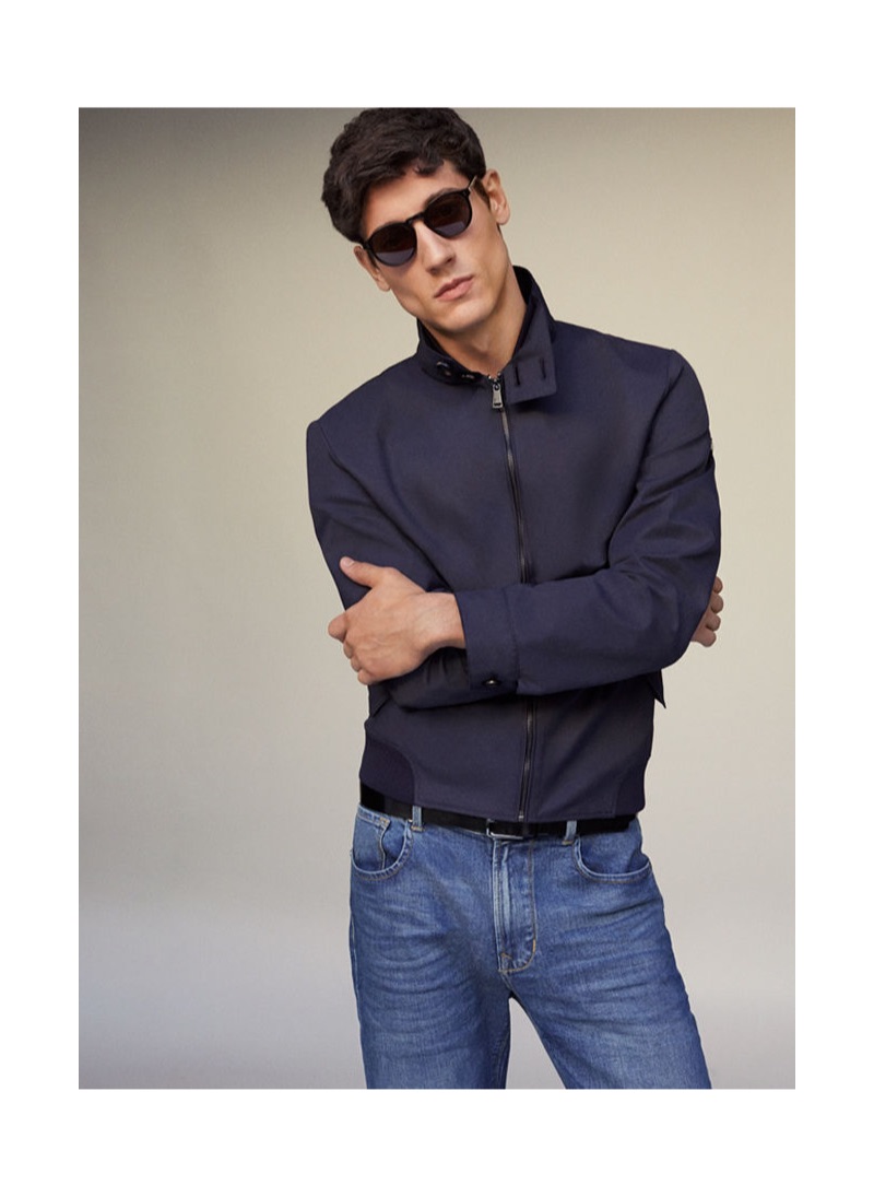 Nicolas Ripoll sports denim jeans and a navy jacket by Pedro del Hierro.