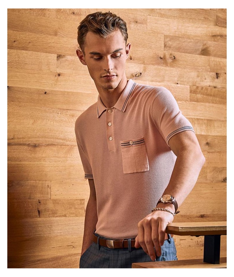 Kit Butler dons a pink tipped cotton silk micro mesh tipped polo by Todd Snyder.