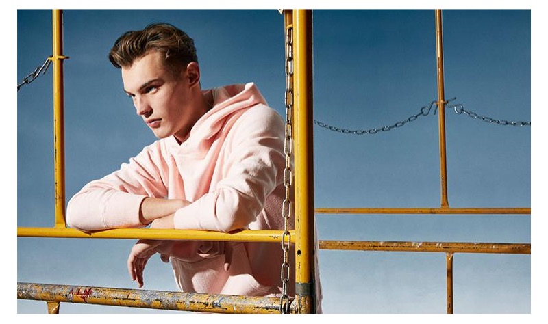 Connecting with Todd Snyder, Kit Butler wears a pink terry popover hoodie from the brand's Champion collaboration.