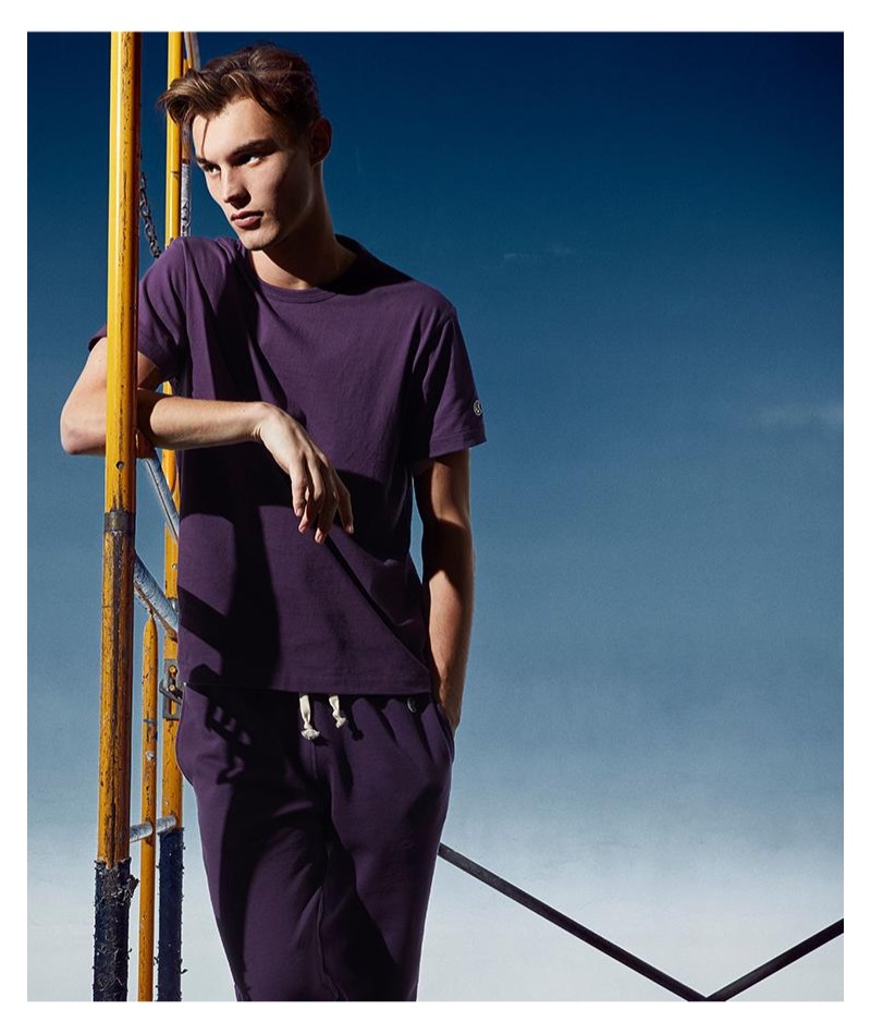 Dressed in purple, Kit Butler rocks a Todd Snyder + Champion tee and terry jogger sweatpants in plum.