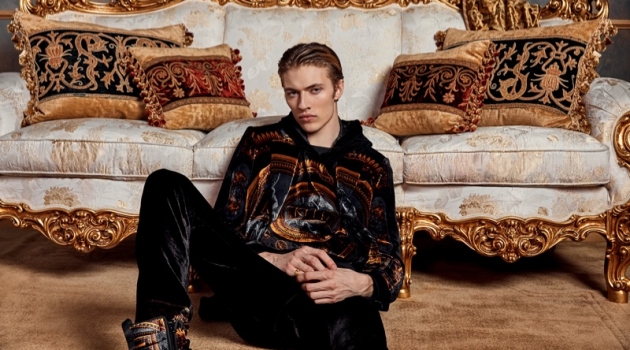 Lucky Blue Smith Embraces Bold Style for Kith x Versace Campaign Relaxing, Lucky Blue Smith wears Kith x Versace.